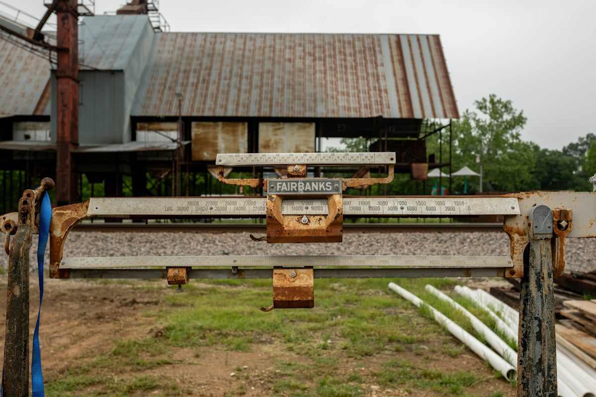 Old industrial equipment with weathered metal building.
