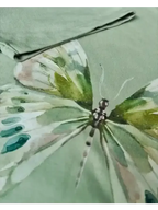 Watercolor butterfly print on soft women's clothing, calm green tones, quiet style for real Indian women